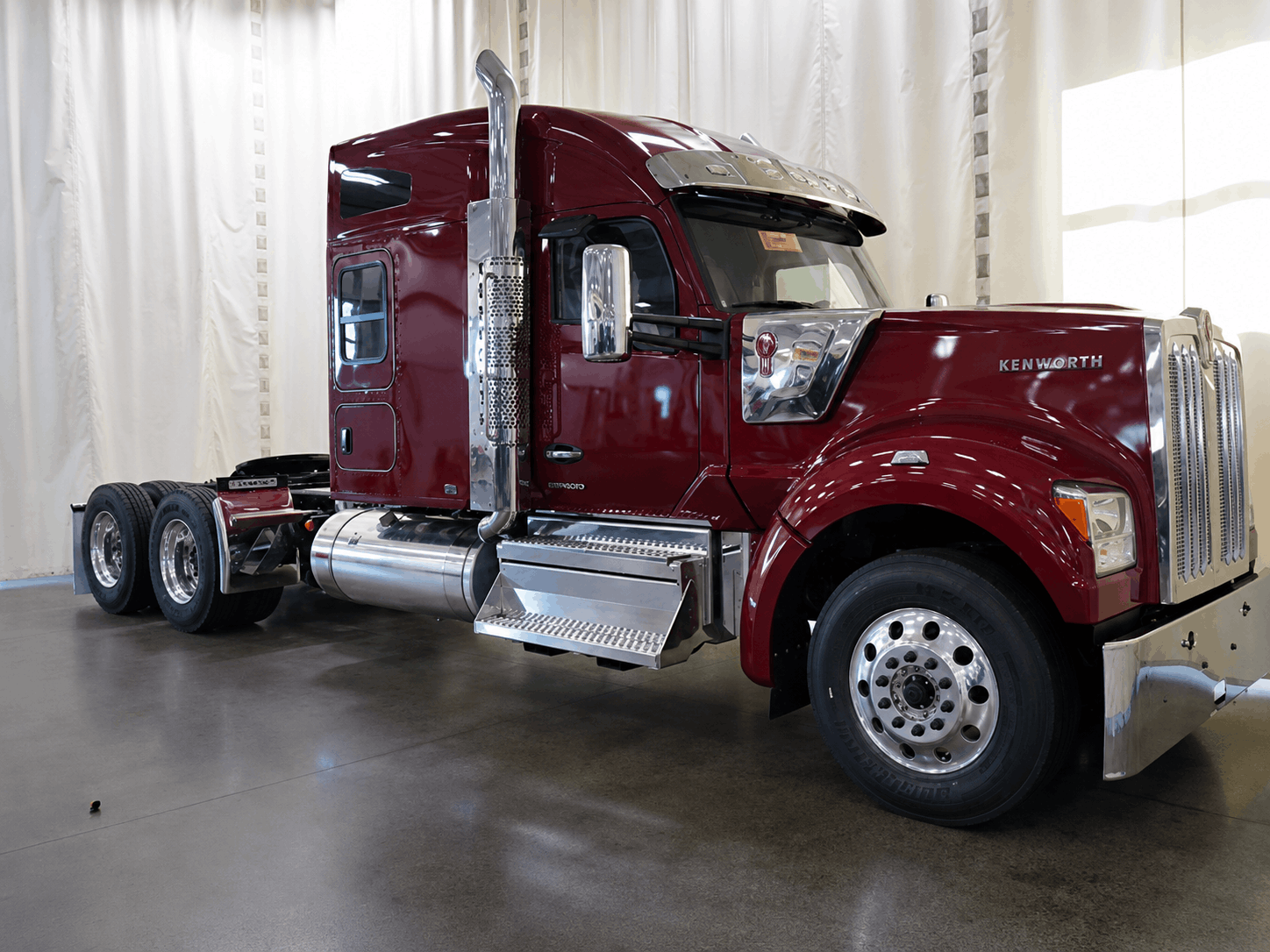 Black Kenworth W990 with OEM-style eyebrow visor